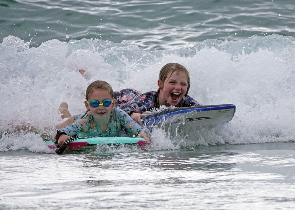 Family boogie boarding in Horseshoe Bay